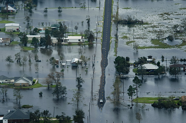 A car reaches the end of dry road in a neighborhood flooded by Hurricane Ike near Winnie, Texas.

