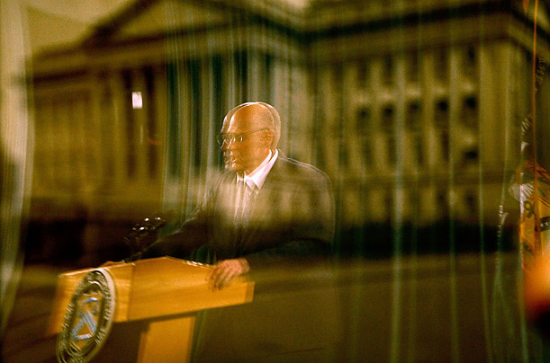 U.S. Treasury Secretary Henry Paulson is reflected in a photograph of the Treasury Department during a news conference called to address the current financial crisis.

