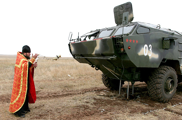 A priest blesses an armored vehicle during Russian army exercises at the Donguz military training range in Orenburg, Russia.

