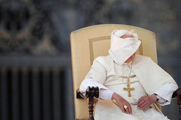 Pope Benedict XVI's face is obscured momentarily by a gust of air during his weekly audience on St. Peter's Square in Vatican City.

