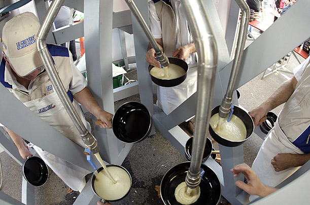 Volunteers and cooks in Switzerland attempt to make the world's largest cheese fondue, using 2156 pounds of cheese and 110 gallons of white wine.

