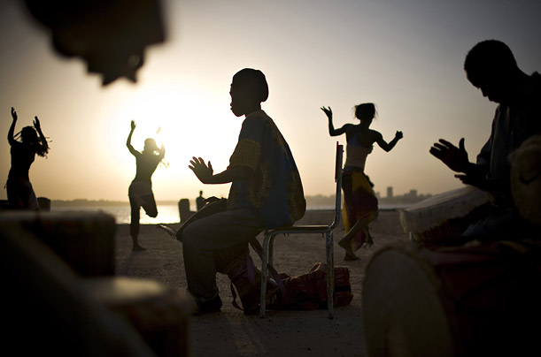 Drummers and dancers rehearse by the ocean in Dakar, Senegal.

