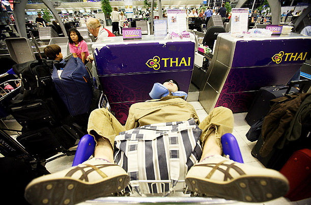 A traveler rests inside Suvarnabhumi airport in Bangkok, where operations were shut down because of a blockade by thousands of anti-government protestors.

