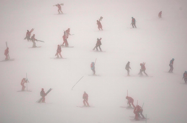 Race organisers, volunteers and journalists descend through snow flurries and strong wind after a men's Slalom race was cancelled due to bad weather at the Audi FIS Ski World Cup Alpine skiing in Val d'Isere, France.

