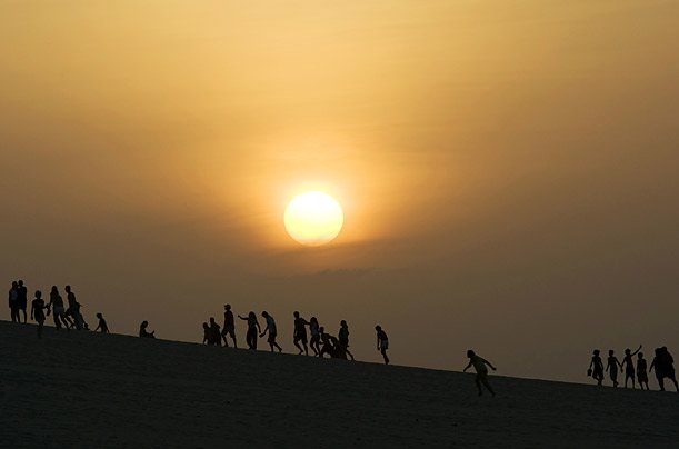 People watch the sun set over the 'Dune of Sunset' in northeastern Brazil. 

