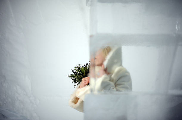 A bride poses for a photographer at the chapel of the ICEHOTEL in Jukkasjaervi, Sweden.