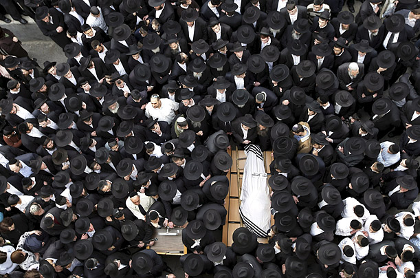Thousands of friends, family and colleagues attend the funeral of Rabbi Avraham Ravitz, a veteran Hassidic Member of the Knesset in Jeruslem.

