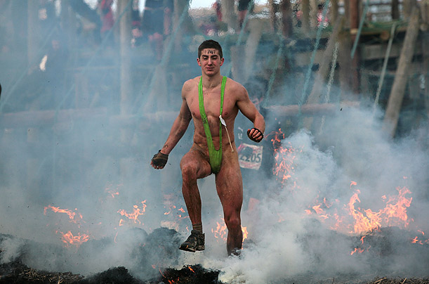 A competitor runs through fire during the Tough Guy Challenge 2009 in England. .

