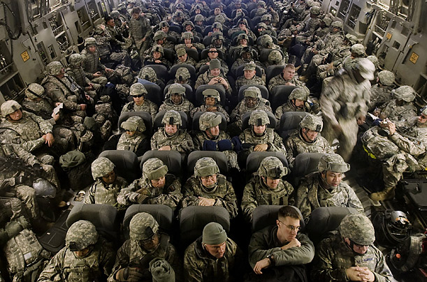U.S. serviceman wait for their flight to Afghanistan to depart from Manas Air Force Base in Bishkek, Kyrgyzstan. After a vote by the Kyrgyz Parliament, the base has been forced to close.

