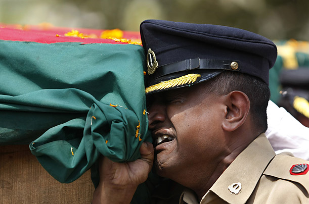 An army soldier cries as he carries the coffin of a Bangladesh Rifles officer during a state funeral for officers killed in the recent mutiny in Dhaka.

