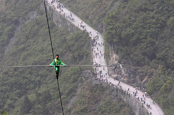 Walking on a 2,300 foot long tightrope set at a 39-degree gradient, Samat Hasanand successfully breaks the Guinness World Record for aerial tightrope walking.
