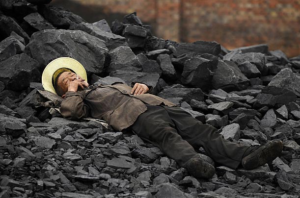 A laborer takes a rest on a cinder dumpsite in Changzhi, China. 
Reuters