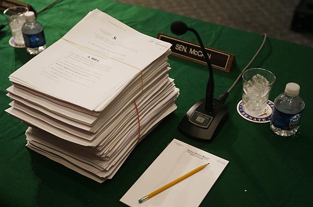 A stack of documents comprising the health care reform bill and its amendments rests at Senator John McCain's place on Capitol Hill.