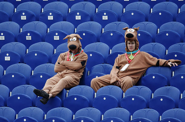 Two spectators in Scooby-Doo outfits sit out a rain break during a cricket game between England and Australia in Cardiff, Wales.