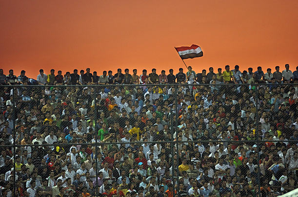 Spectators watch a friendly soccer match between Iraqi and Palestinian teams in Kurdistan, Iraq.