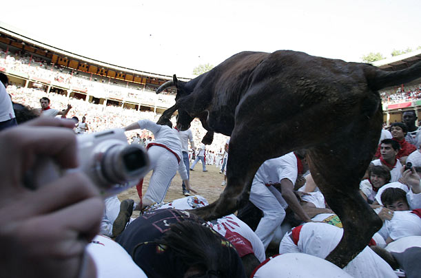 A heifer leaps over a pile of runners following the running of the bulls in Pamplona, Spain.