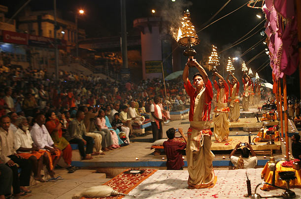 Hindu priests hold lamps as they perform evening prayers on the banks of the river Ganges in Varanasi, Indian.