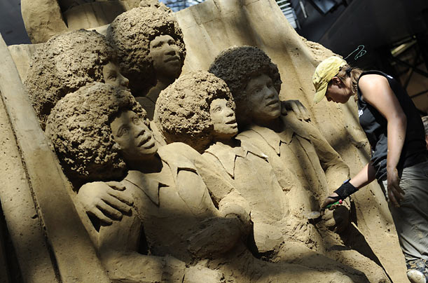 Finishing touches are placed on a sand sculpture of the Jackson Five in a shopping center in Berlin, Germany.