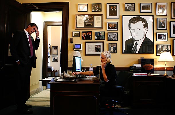 Henry Sanford, left, Staff Assistant of the office of U.S. Senator Edward Kennedy, pauses as Staff Assistant Meagen Manning, right, answers
