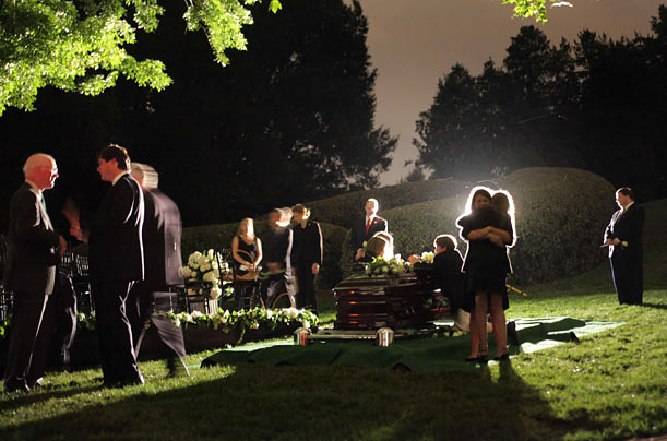 Family members gather at the coffin of Senator Edward Kennedy at Arlington National Cemetery in Arlington, Virginia.