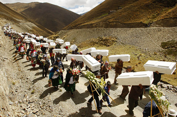 Relatives of victims killed in a massacre during Peru's 20-year civil war carry their remains to the families for proper burial.