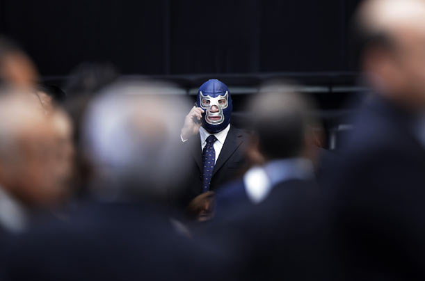 Mexican wrestler Blue Demon takes a call as he arrives for Mexican President Felipe Calderon's third annual state of the nation