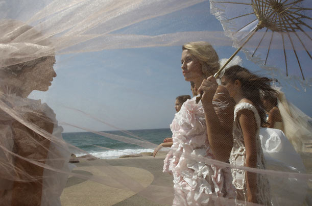 Israeli models wearing wedding dresses made mostly from toilet paper