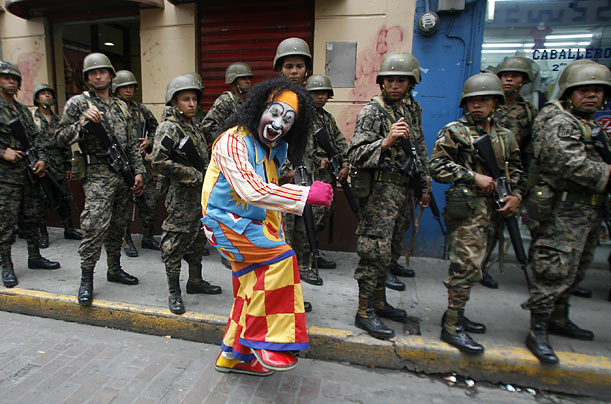 Why So Serious?
A clown goofs off as soldiers march in Tegucigalpa, Honduras.