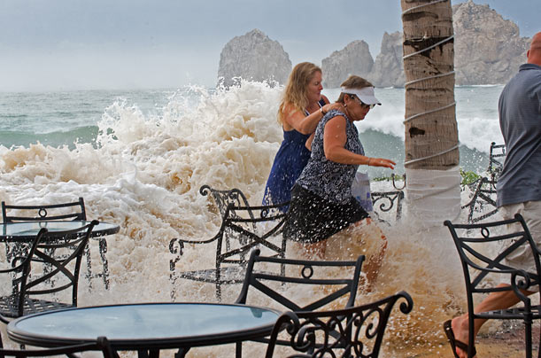 Worst. Vacation. Ever.
People flee the deck of a hotel in Cabo San Lucas, Mexico as large waves from Hurricane Rick overtake their perch.