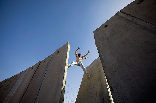 Small Triumph
A Palestinian demonstrator scales the Israeli separation barrier, moments after knocking down one of its segments, during