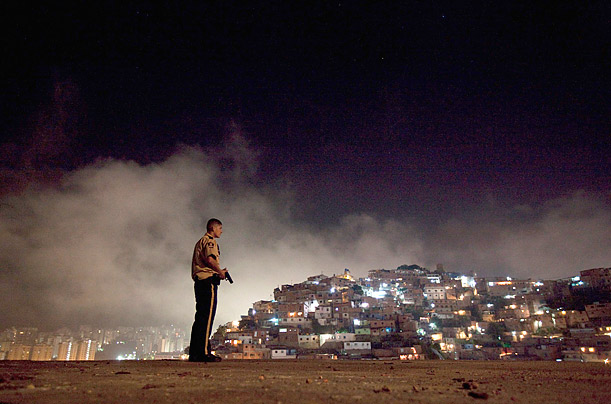 A policeman patrols the slum district of Petare in Caracas, Venezuela.