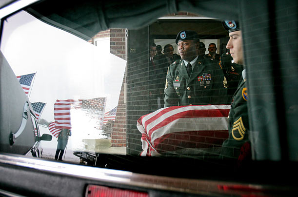 Coming Home
Soldiers load Pfc. Jaiciae L. Pauley's coffin into a hearse at the Garden View Funeral Home.