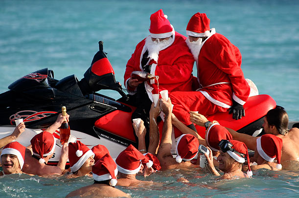 Wet Bar
Two men dressed as Santa Claus fill the cups of swimmers during a pre-Christmas dip in the Mediterranean sea at Villeneuve Loubet, France.
