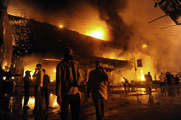 Mired in Violence
Angry protesters set a market ablaze after a suicide blast killed at least 30 people in Karachi during the religious festival of Ashura.