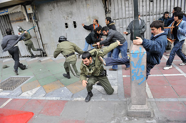 Backlash
Iranian protestors beat police officers during an anti-government protest in Tehran.