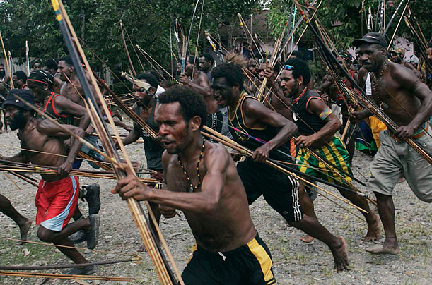 Conflict
Dani warriors attack the Damal tribe during a skirmish in the village of Old Kwaki in Papua, Indonesia. The confrontation