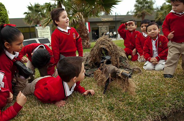 Uniform

Children play with a soldier wearing a ghillie suit during Army Day celebrations in Tijuana, Mexico.
