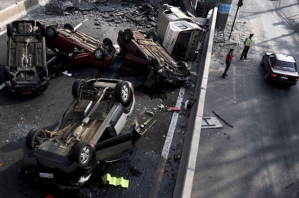 Pictures of the Week: Cars lie overturned after the highway they were travelling on was destroyed in an earthquake in Santiago February 27, 2010. A huge magnitude-8.8