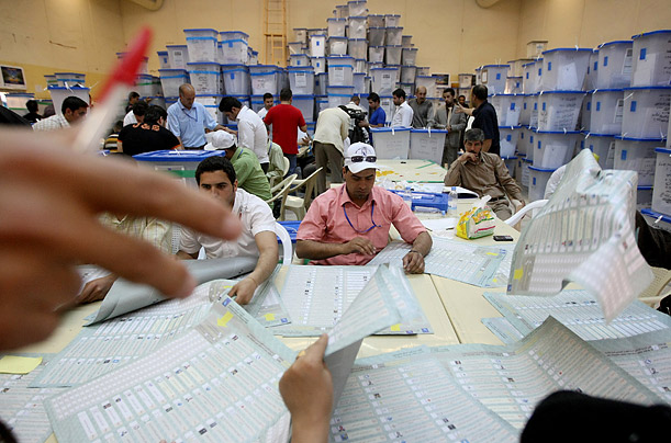 Iraqis count votes at the Independent High Electoral Commission (IHEC) headquarters in Baghdad on March 11, 2010, following Iraq's second general elections since the