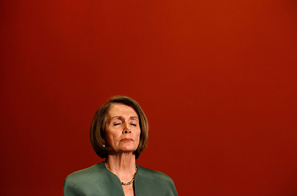 In Washington DC, Nancy Pelosi listens to reporters' questions after signing the Hiring Incentives to Restore Employment Act.