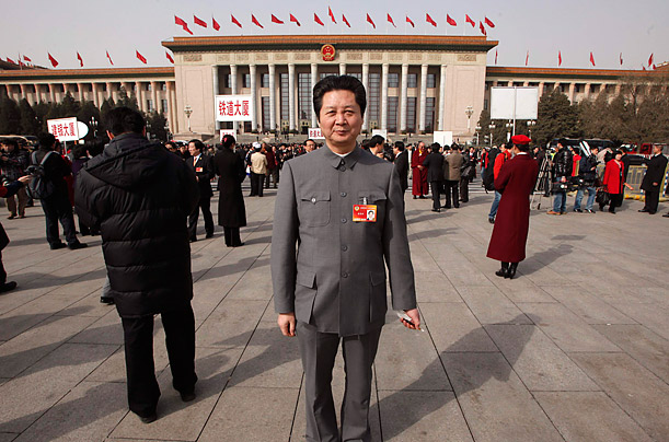 Lou Yuangong, an impersonator of Mao Zedong, stands in front of the Great Hall of the People on Tiananmen Square.