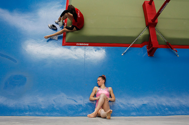 During the South American Games in Medellin, Colombia, Argentinean gymnast Valeria Pereyra, stretches her legs against the wall prior to competition.



