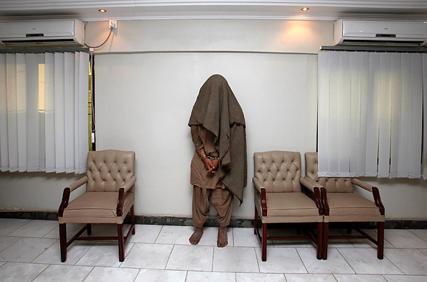 An arrested member of the outlaw militant group Lashkar-e-Jhangvi is presented to the media at the Police Crime Investigation Department in Karachi, Pakistan.