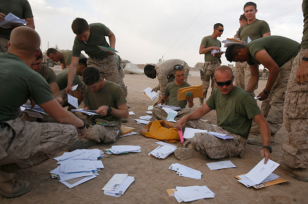 U.S. Marines from Kilo company collect their mail at their base in the Marjah district of Helmand province in Afghanistan.