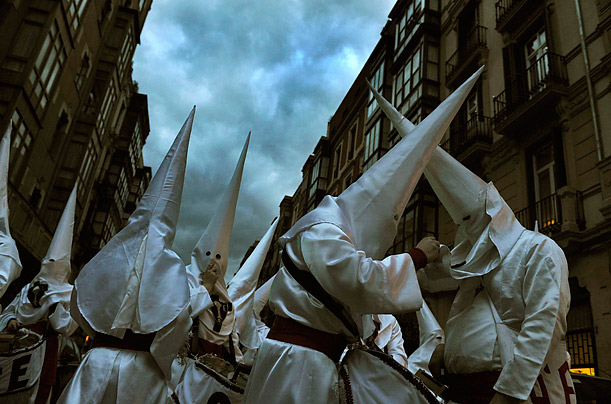Penitents prepare their costumes before a procession during Holy Week in Bilbao, Spain.