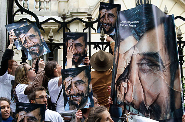 Members of the Paris-based organization Reporters Without Borders hold pictures of Iranian President Mahmoud Ahmadinejad as they demonstrate outside the Iranian embassy in Paris to mark Press Freedom Day.