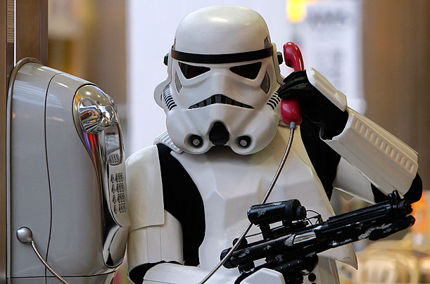 A Hungarian Star Wars fan dressed as a storm trooper makes a phone call during the 30th anniversary celebrations of [ITALIC 
