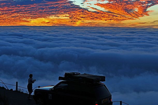 A tourist on Signal Hill looks at a sunset in Cape Town, South Africa.