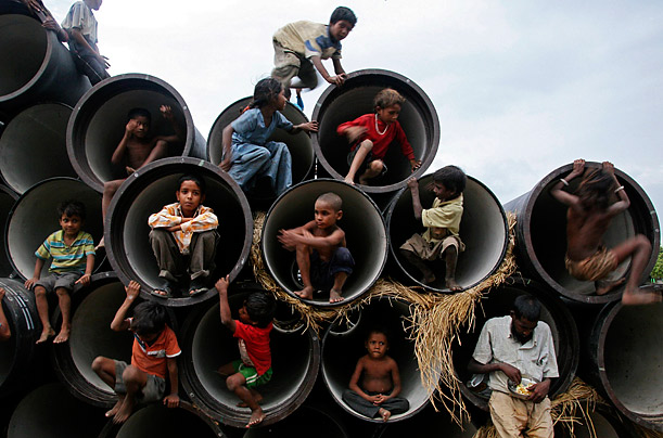Children play in water pipes at a construction site on the banks of the Yamuna River in the northern Indian city of Allahabad. 
