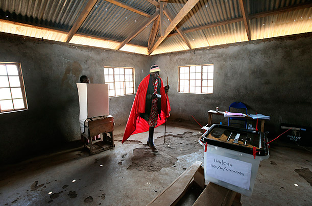 A Masai tribesman prepares to cast his vote during a referendum on a constitution for Kenya.


